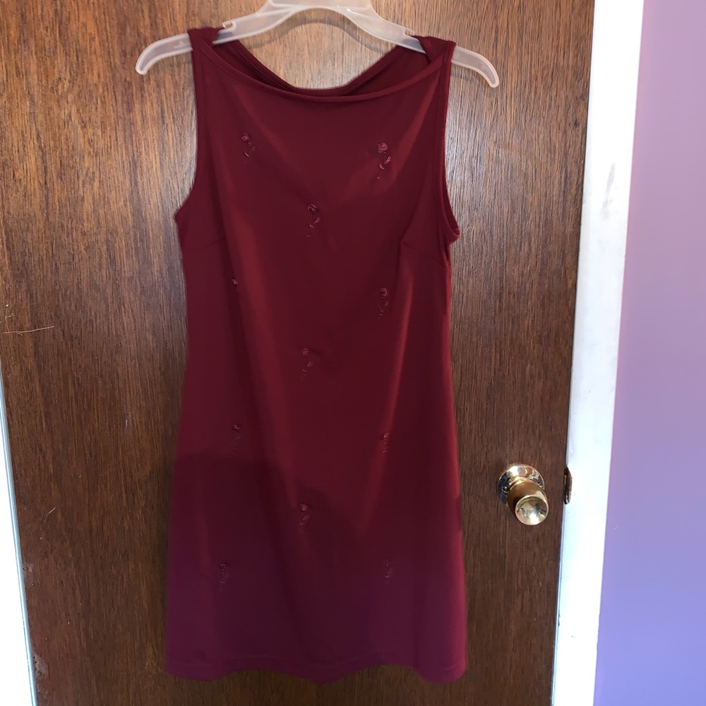 deep red dress with sewn rose pattern